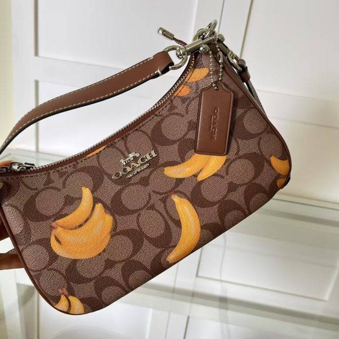 Women's COACH Teri Shoulder Bag - Brown Signature Canvas with Banana Print - Fashion Accessory